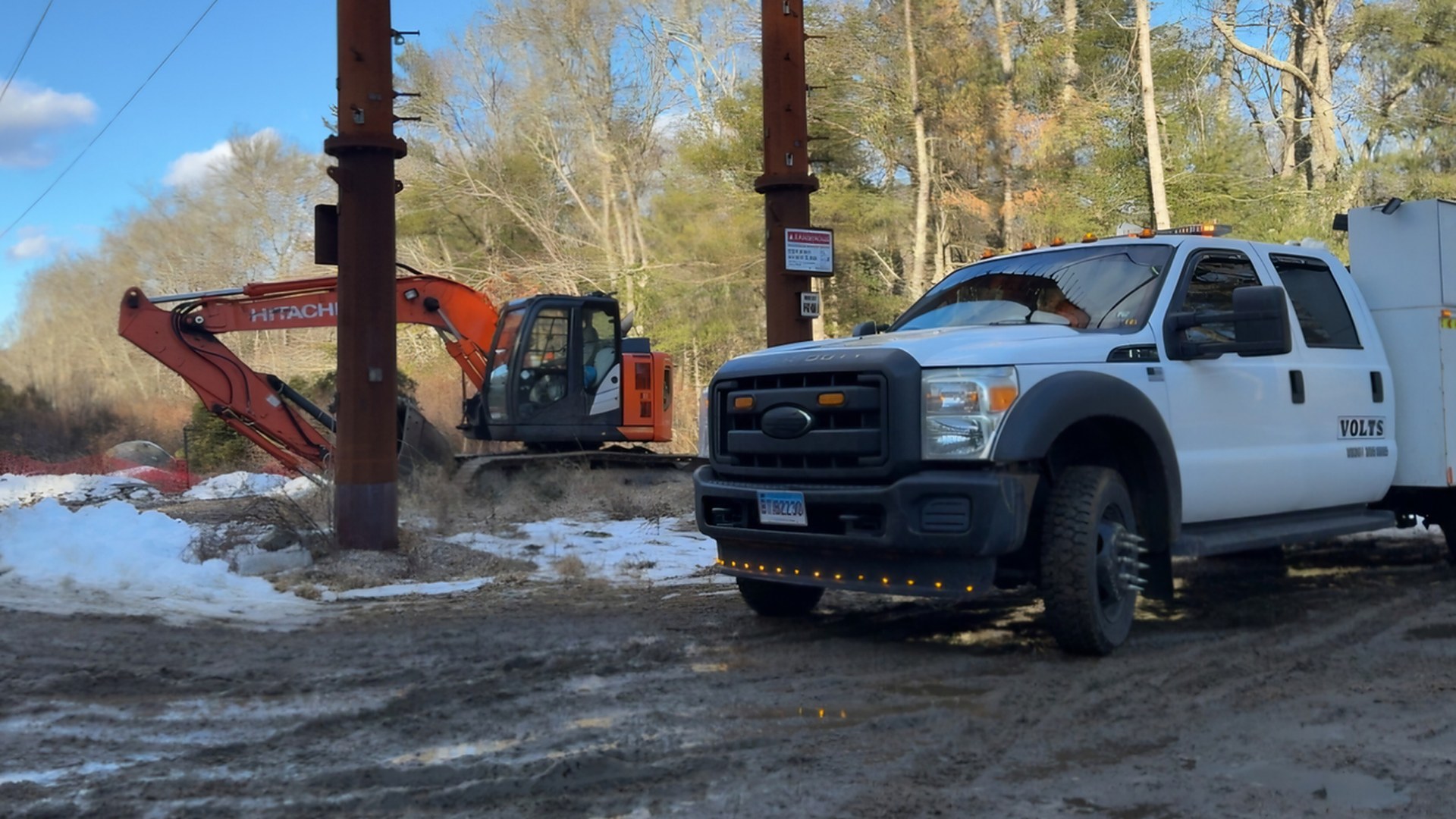 VOLTS service truck on a utility jobsite with an excavator